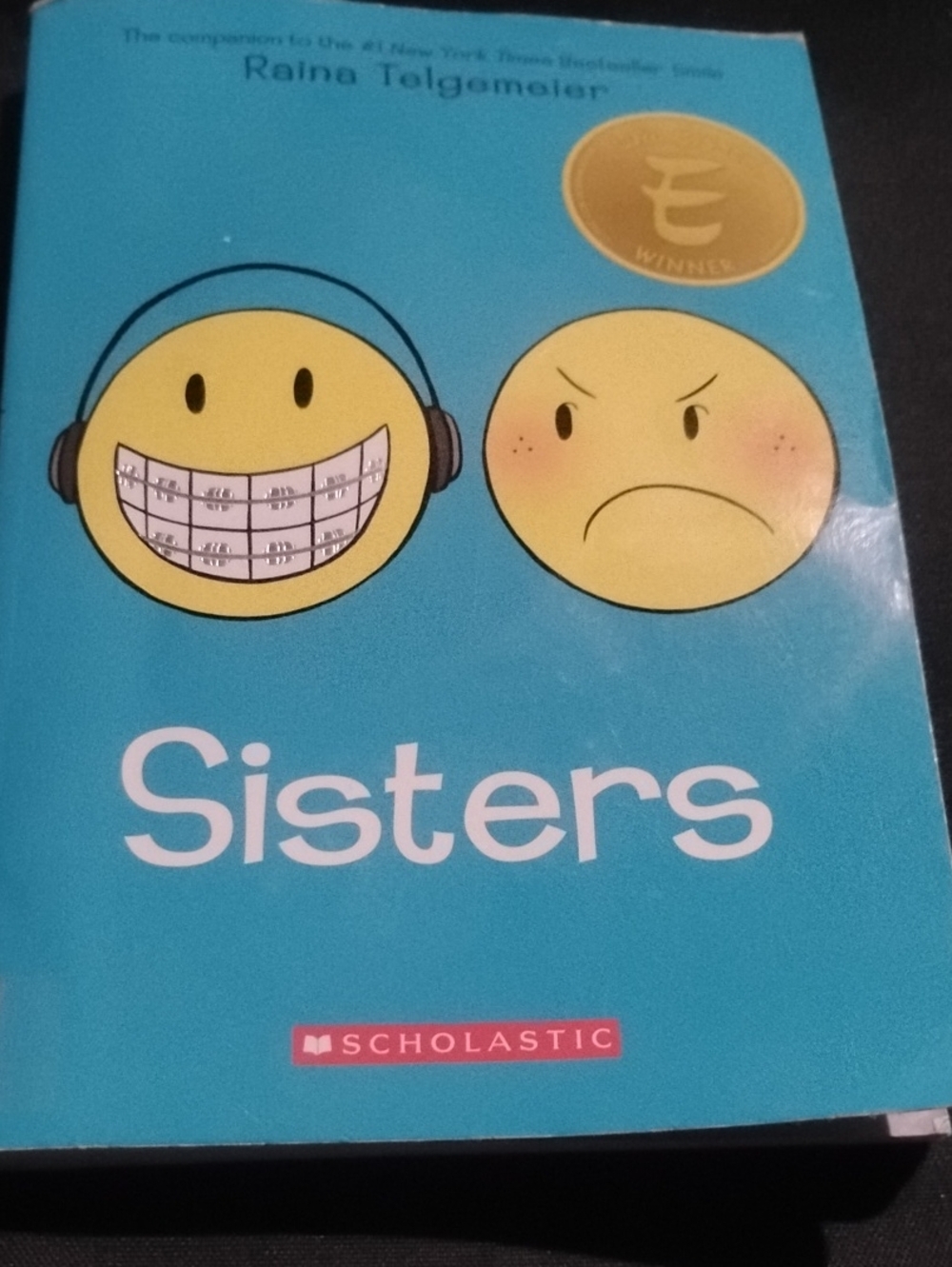 Scholastic Teal Cover Graphic Novel with Yellow Emoji Faces